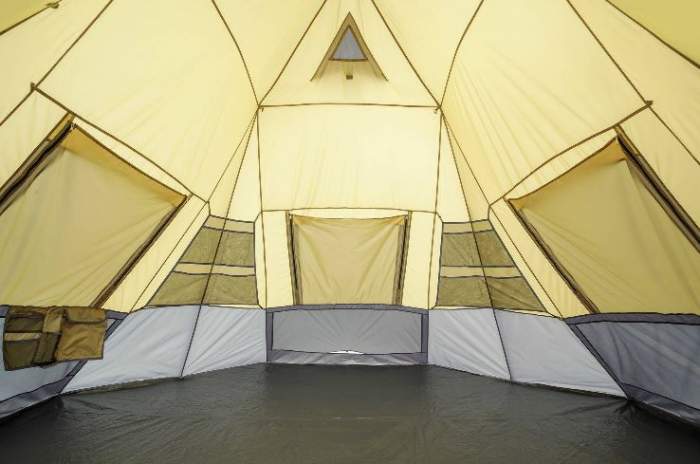 Inside view with floor vent on the opposite side, storage pouches on the walls, and panels on windows.