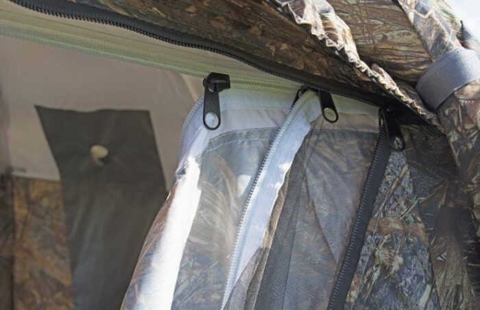 Three layers on the door, the awning rolled to the side and fixed with a strap is also partly visible.