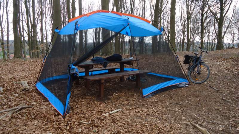 YDYL Screen House pitched over a fixed table in the park.