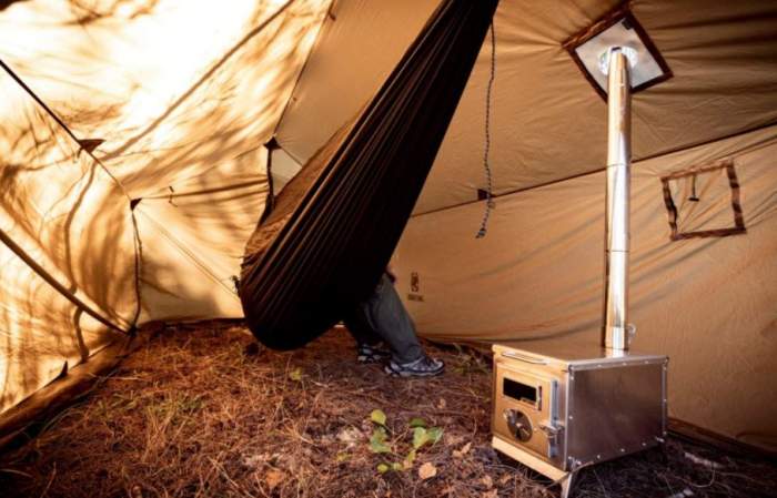 View inside with a hammock and a wood burning stove.